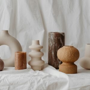 A curated assortment of unique ceramic vases in neutral tones, showcasing modern rustic design.