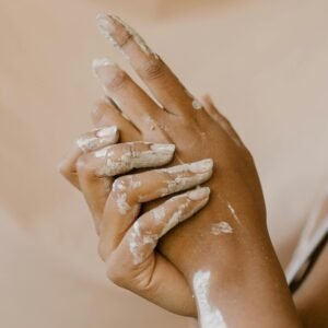 Detailed shot of hands with dried clay, symbolizing artistry and craftsmanship.